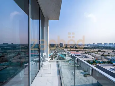 a balcony with chairs and a view of an airport at Zapbed House-luxury one bedroom apartment in Residence 16 in Dubai