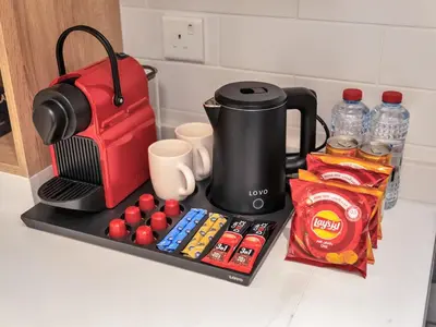 a kitchen counter with a coffee maker and food and drinks at Luxurious 3BR Stunning Canal & Burj Khalifa View in Dubai