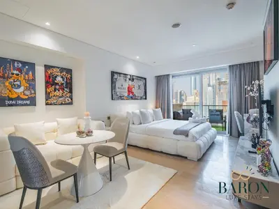 a large living room with a bed and a table at The Gallery in Dubai