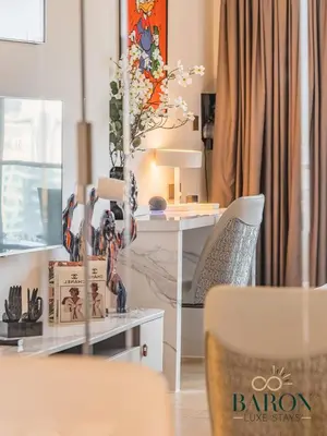 a living room with a table and a chair at The Gallery in Dubai