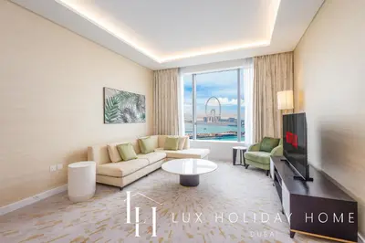 a living room with a couch and a tv at LUX Iconic Views at The Palm Tower Suite 6 in Dubai