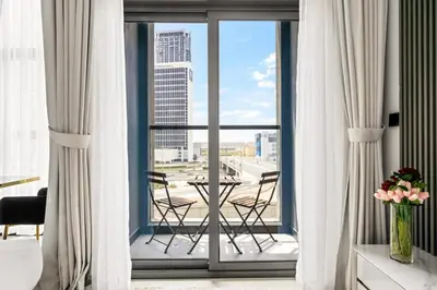 a room with a balcony with a table and chairs at Luxury Studio Business Bay Short Stays Long Stays in Dubai