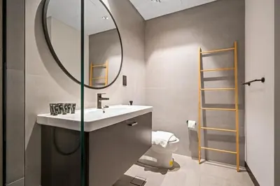 a bathroom with a sink and a mirror and a toilet at Luxury Studio Business Bay Short Stays Long Stays in Dubai