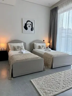 a bedroom with two beds and a window at Luxury Brand new 2BR nearby DIFC in Dubai