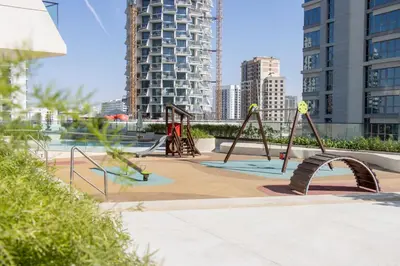 a playground in a city with tall buildings at Modern 1B with Private Jacuzzi Binghatti Phantom, JVC in Dubai
