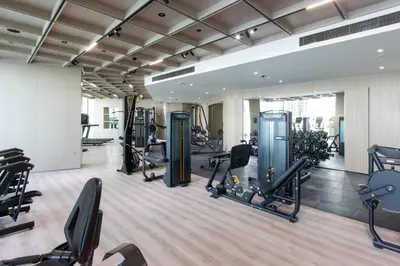 a gym with treadmills ellipticals and exercise bikes at Modern 1B with Private Jacuzzi Binghatti Phantom, JVC in Dubai