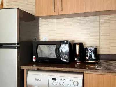a microwave sitting on top of a kitchen counter at ASHRI HH | Spacious Studio in Arjan in Dubai