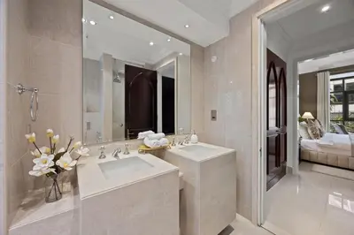 a bathroom with two sinks and a large mirror at Authentic Arabic Lux Stay -Seconds to Burj Khalifa in Dubai