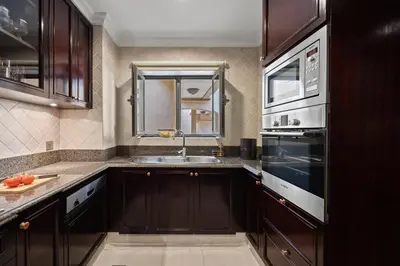 a kitchen with a sink and a microwave at Authentic Arabic Lux Stay -Seconds to Burj Khalifa in Dubai