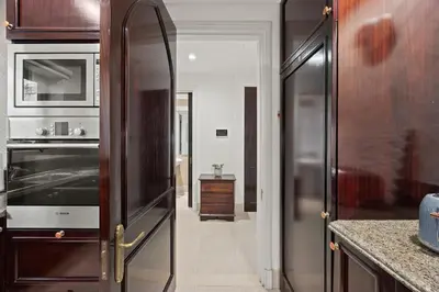 a kitchen with a microwave and a refrigerator at Authentic Arabic Lux Stay -Seconds to Burj Khalifa in Dubai