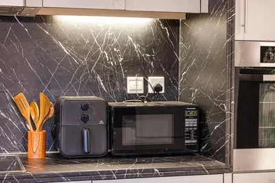 a microwave sitting on a counter in a kitchen at Full Burj Khalifa Fountain View Near Dubai Mall Downtown in Dubai