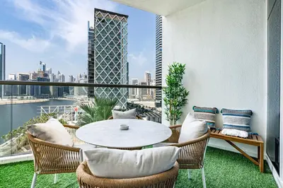 a balcony with a table and chairs and a view of the city at Sleek Home in Business Bay with Panoramic Views in Dubai