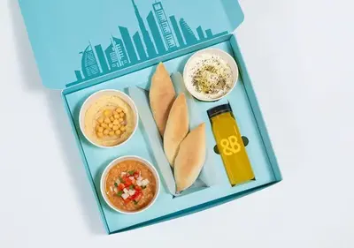a picture of a lunch box with food and drinks at Cosmos Living Work-Friendly with Easy Metro Access in Dubai