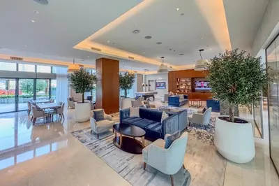 a lobby with a couch and chairs and tables at High-End 2Bedroom Near Dubai Opera & Mall in Dubai