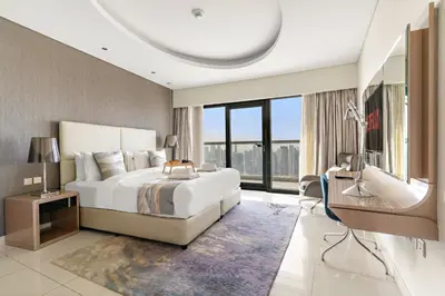 a bedroom with a large bed and a large window at VayK - Luxurious 3BR in Business Bay with Burj Khalifa View in Dubai