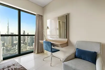 a room with a chair and a desk and window at VayK - Luxurious 3BR in Business Bay with Burj Khalifa View in Dubai