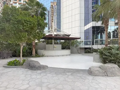 a courtyard in a building with trees and rocks at VayK - Luxurious 3BR in Business Bay with Burj Khalifa View in Dubai