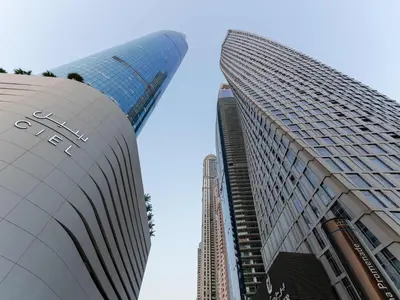 two tall buildings in a city with a blue sky at Cayan Tower, The Twist - Marina Views & Free Pool in Dubai