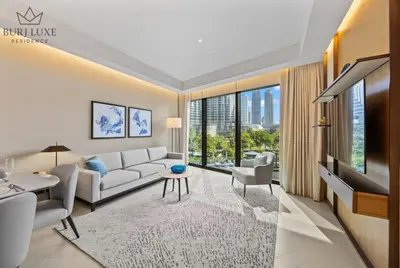a living room with a couch and a tv at Address Residences Dubai Opera 3-bed Full Burj & Fountain View, Downtown Dubai in Dubai
