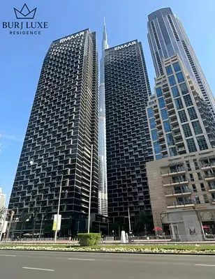 three tall buildings in a city with a street at Address Residences Dubai Opera 3-bed Full Burj & Fountain View, Downtown Dubai in Dubai