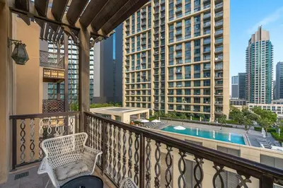 a balcony with a view of a pool and buildings at Charming Oasis Near Dubai Mall & Burj Khalifa in Dubai