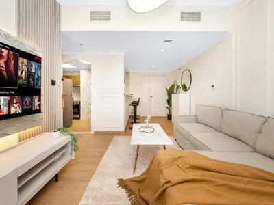 a living room with a couch and a tv at New Lux 3BR Apartment High Floor Prime Location BCOM in Dubai