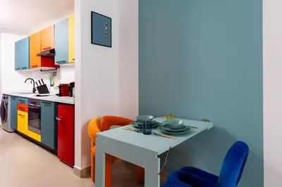 a small kitchen with a table and chairs at Waves - Vibrant JLT Stay - Modern Funky Studio in Dubai