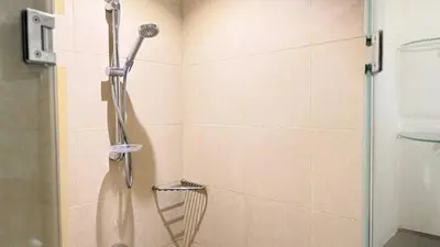 a shower with a shower head in a bathroom at ASHRI HH | Elegant 2 BHK| Downtown Dubai | 8Blvd in Dubai
