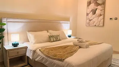 a bedroom with a large bed with a large headboard at ASHRI HH | Elegant 2 BHK| Downtown Dubai | 8Blvd in Dubai