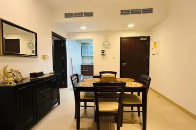a dining room with a table and chairs at Cosy 1 Bed in JLT in Dubai