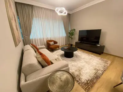 a living room with a couch and a tv at Comfy 1 Bedroom in Dubai Marina in Dubai