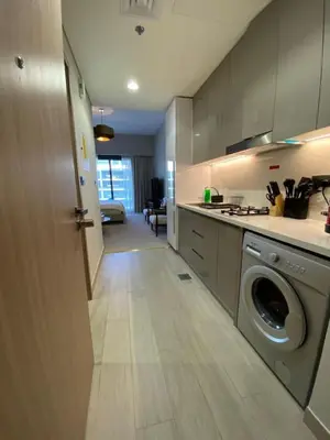 a kitchen with a washer and dryer in a room at Bright Studio - Azizi Riviera 35 - Fully Furnished in Dubai