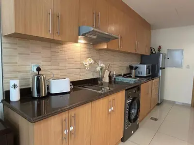 a kitchen with a sink and a stove top oven at Modern Studio - Lincoln Park West - Dubai, Arjan in Dubai