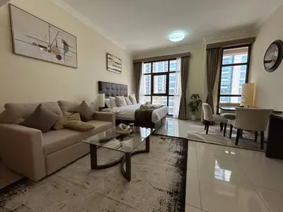 a living room with a couch and a table at Modern Studio - Lincoln Park West - Dubai, Arjan in Dubai