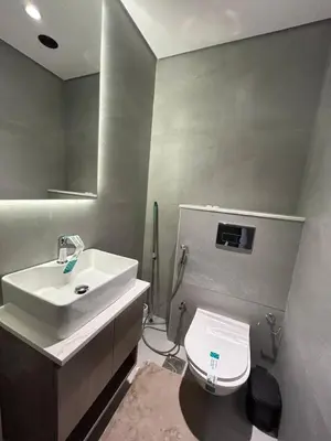 a bathroom with a white sink and a toilet at Stylish 1-Bed Apartment in Laya Heights, Dubai in Dubai