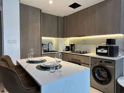 a kitchen with a table with wine glasses on it at Stylish 1-Bed Apartment in Laya Heights, Dubai in Dubai