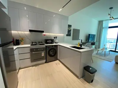 a kitchen with white cabinets and a dishwasher at 1-Bedroom in Binghatti Emerald 1 with free Pool and Gym in Dubai