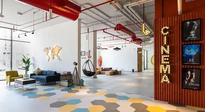 a living room with a blue couch and a floor at ASHRI HH | Elegant Studio | UNA Townsquare in Dubai
