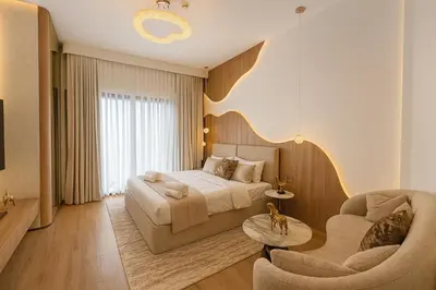a bedroom with a bed and a couch and a table at Designer Studio near Downtown & Dubai Mall in Dubai
