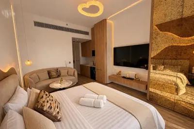 a bedroom with a large bed and a couch at Designer Studio near Downtown & Dubai Mall in Dubai