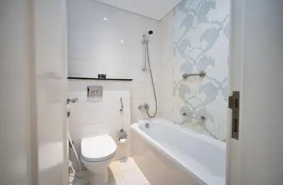 a bathroom with a toilet and a tub and a sink at Stylish Studio in Business Bay Walking to Canal and Downtown in Dubai