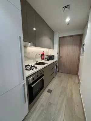 a kitchen with a sink and a stove top oven at Azizi Riviera 41 - Meydan by Golden Casa in Dubai
