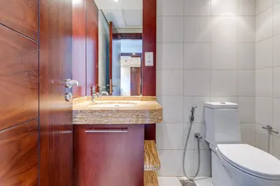 a bathroom with a sink and a toilet at Burj Views Tower, 1 Bdr Apartment with Opera View in Dubai