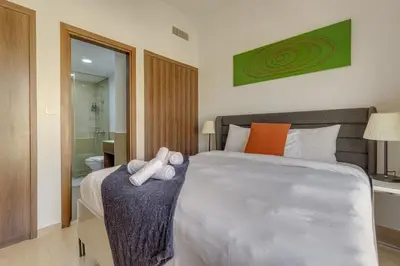 a bedroom with a large bed with towels on it at Remraam, 1 Bedroom in Al Ramth 11 - Allsopp & Allsopp in Dubai