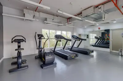 a gym with several cardio machines in a room at Remraam, 1 Bedroom in Al Ramth 11 - Allsopp & Allsopp in Dubai