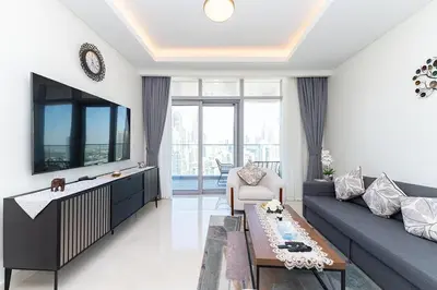 a living room with a couch and a table at Luxury 3BR Imperial Avenue Burj Khalifa Views in Dubai