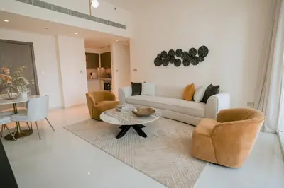 a living room with a couch and chairs and a table at Cozy Apartment with Private Beach & Palm Views in Dubai