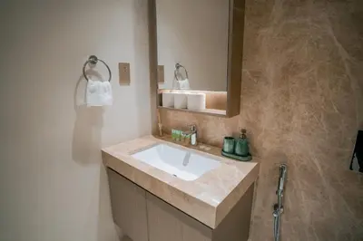 a bathroom with a sink and a mirror at Cozy Apartment with Private Beach & Palm Views in Dubai