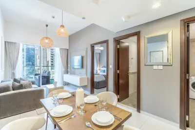 a living room with a table and a couch at RH - Burj Khalifa view with large balcony, 02BR retreat in business bay in Dubai