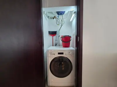 a washing machine with a bucket on top of it at Vacay Lettings 1 bed with burj Khalifa View in Dubai